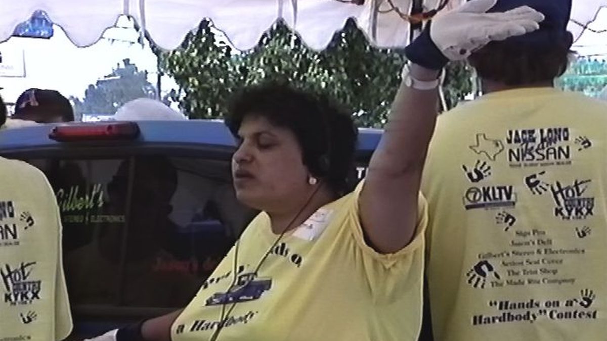 A contestant with her arm raised